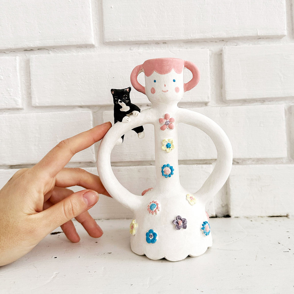 A Woman with a Tuxedo Cat Candle Holder